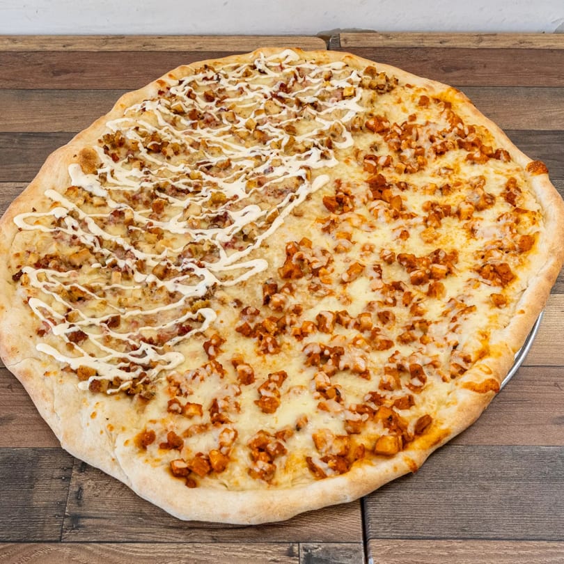 A Pizza Chop pizza, half with white sauce and chicken, half with red sauce and chicken.